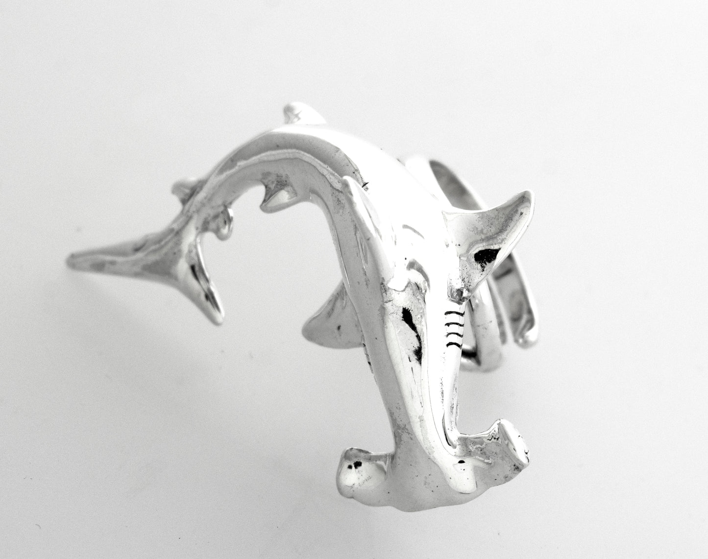 
                  
                    A sterling silver Hammerhead Shark Ring on a white surface.
                  
                
