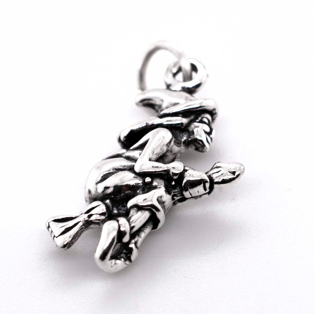 A Witch on a Broomstick Charm by Super Silver, in silver.