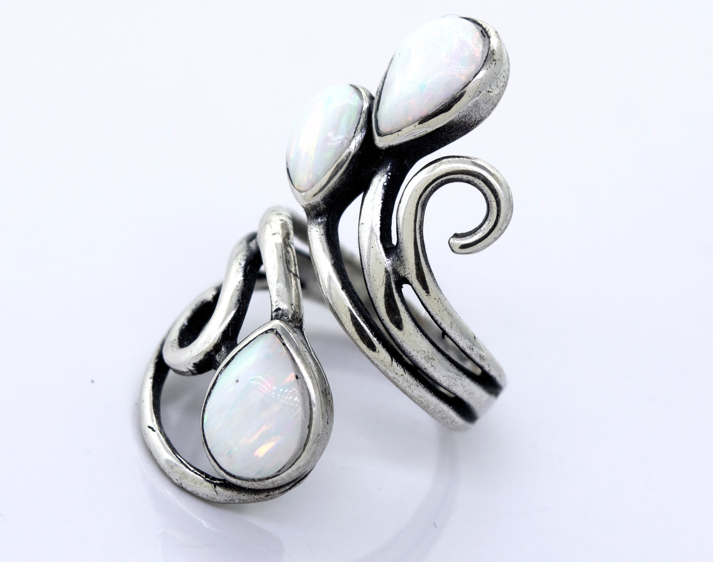 
                  
                    A handcrafted Super Silver Stunning Wrap-Around Opal Ring with white opals and swirling design.
                  
                