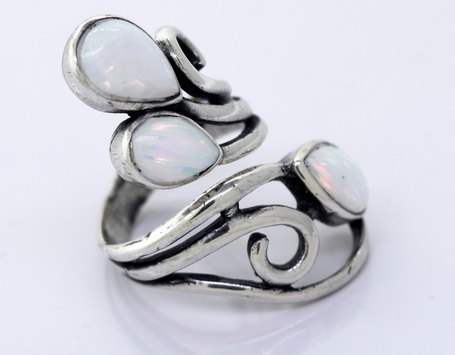 
                  
                    A Super Silver Stunning Wrap-Around Opal Ring handcrafted with opal stones, featuring elegant swirls design.
                  
                