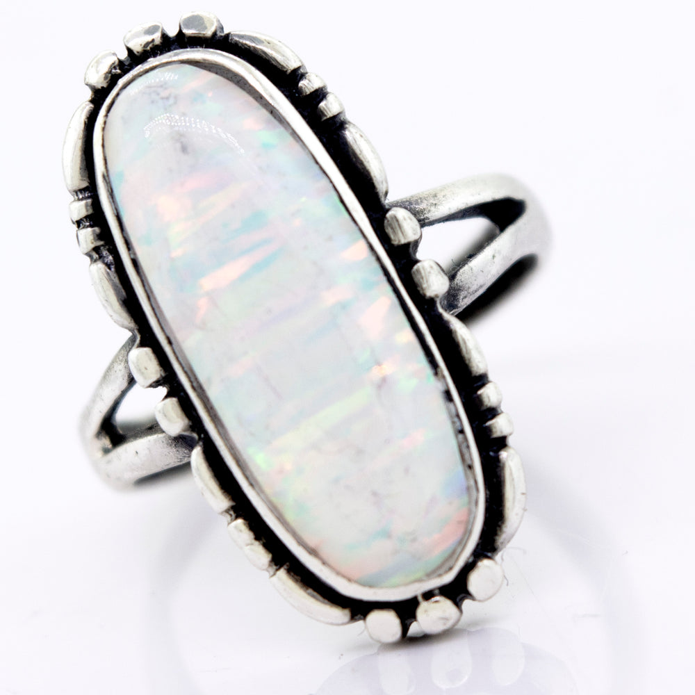 
                  
                    A handcrafted American Made Oval Opal Ring with a southwestern-styled design on a white surface by Super Silver.
                  
                