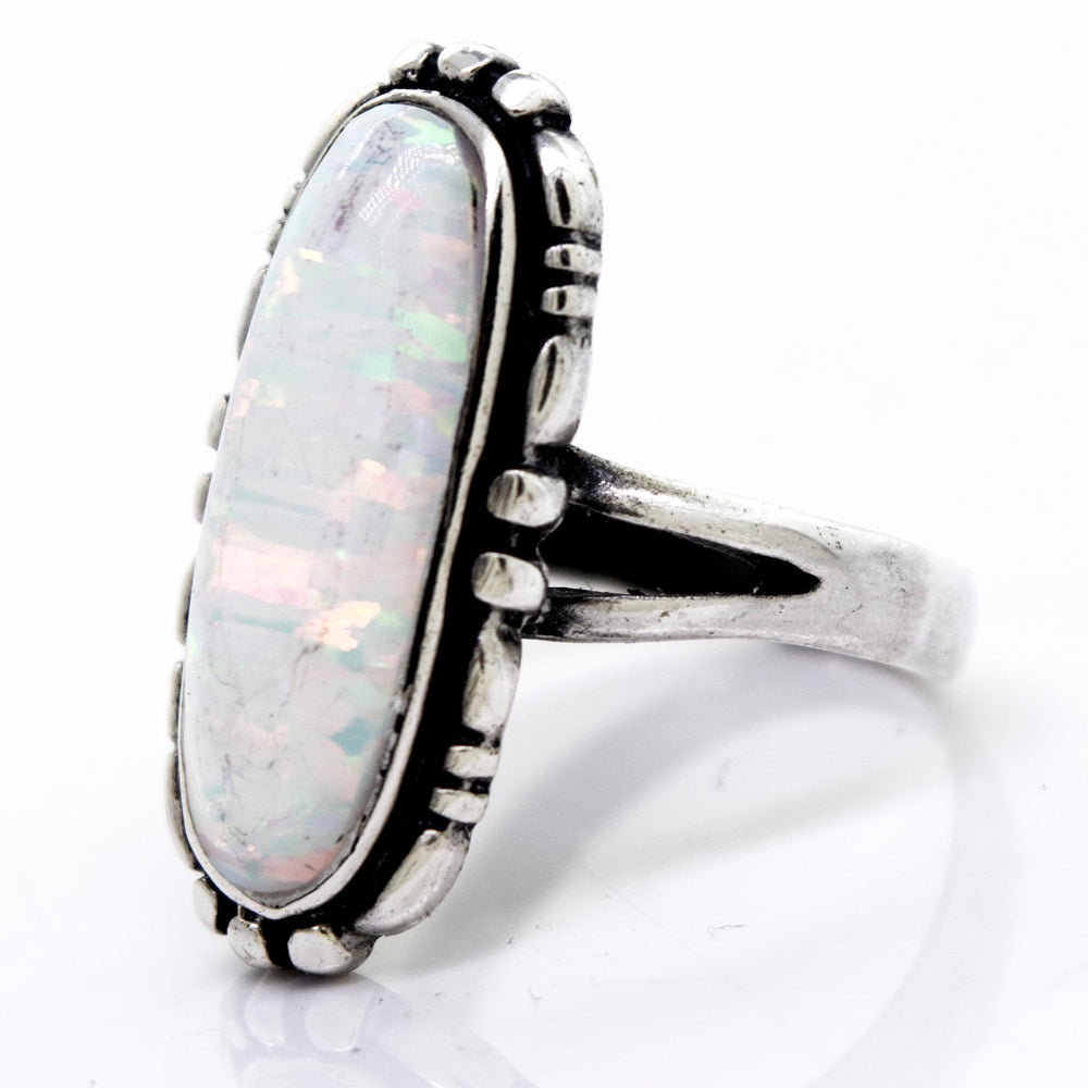 
                  
                    A Super Silver American Made Oval Opal Ring placed on a white surface.
                  
                