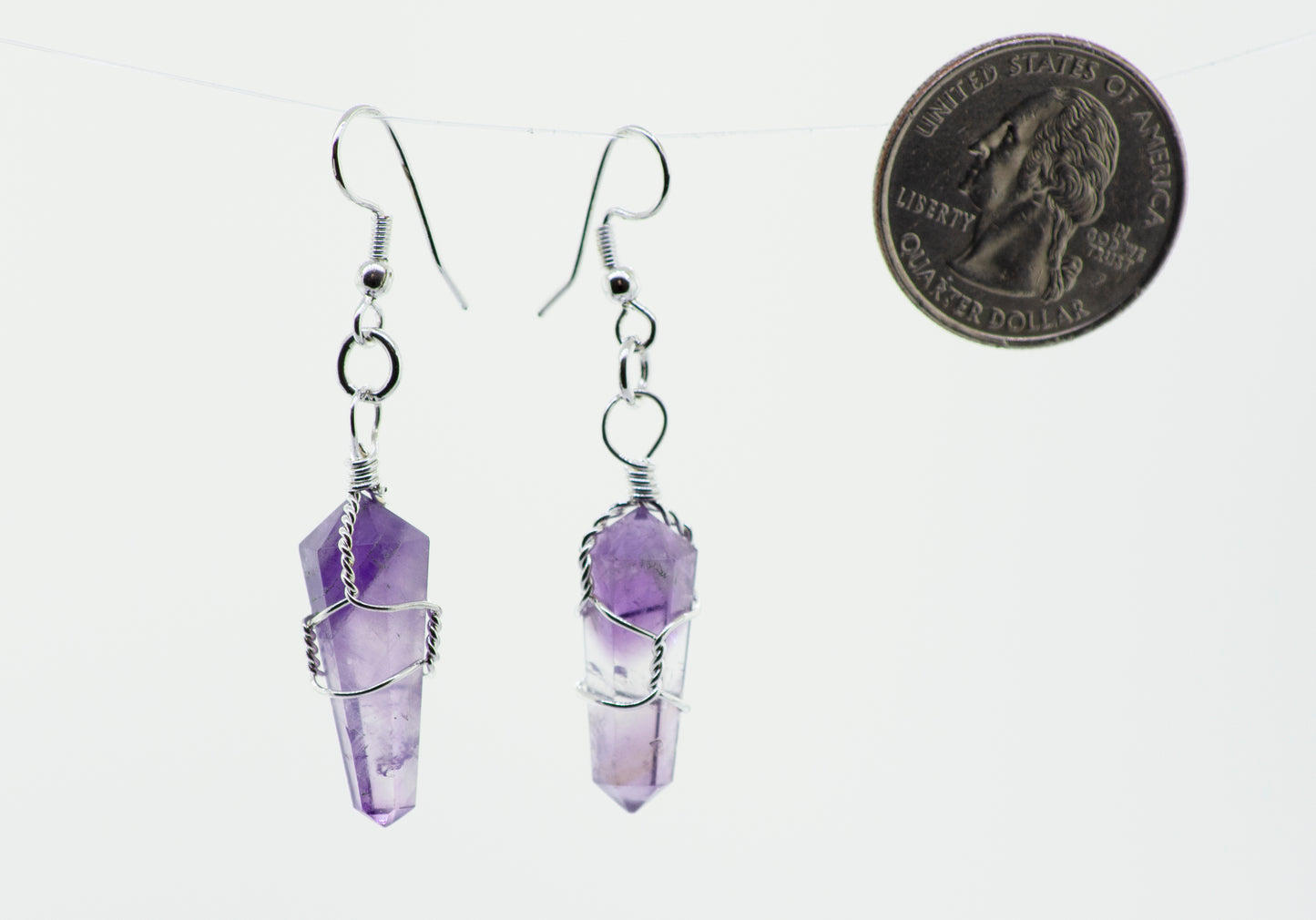 
                  
                    Genuine Wire Wrapped Stone earrings with a dime hanging from them, perfect for everyday wear. The brand name is Super Silver.
                  
                
