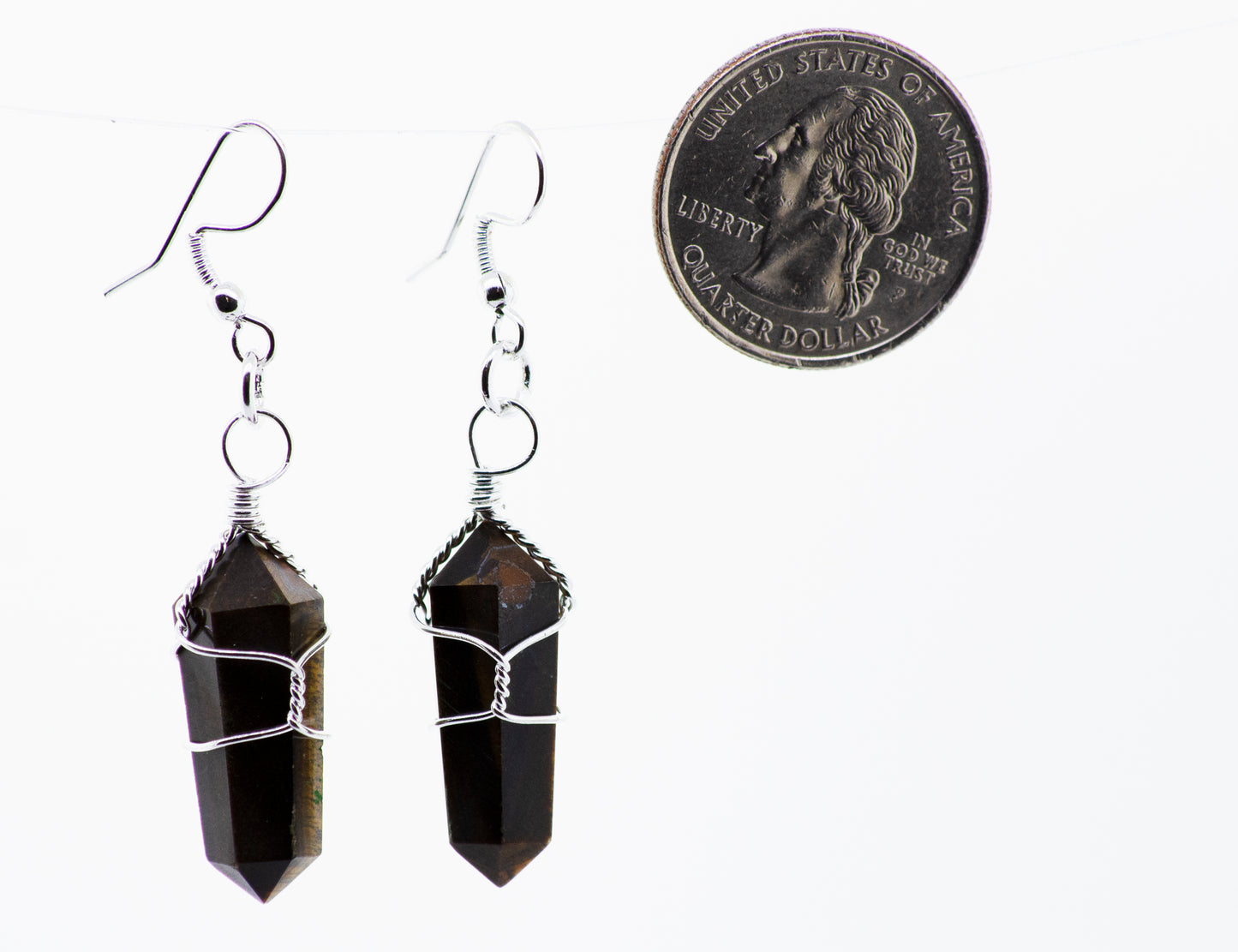 
                  
                    A pair of Super Silver Wire Wrapped Stone Earrings with a dime hanging from them in mixed metal.
                  
                
