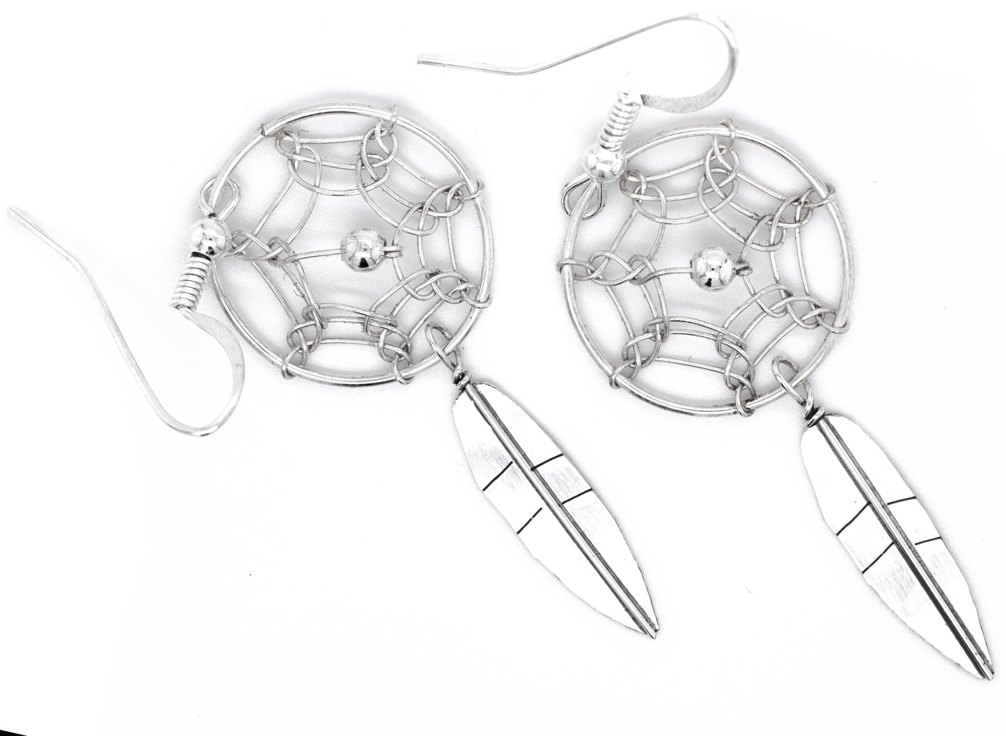 
                  
                    An authentic pair of Super Silver Zuni dreamcatcher earrings on a white background.
                  
                