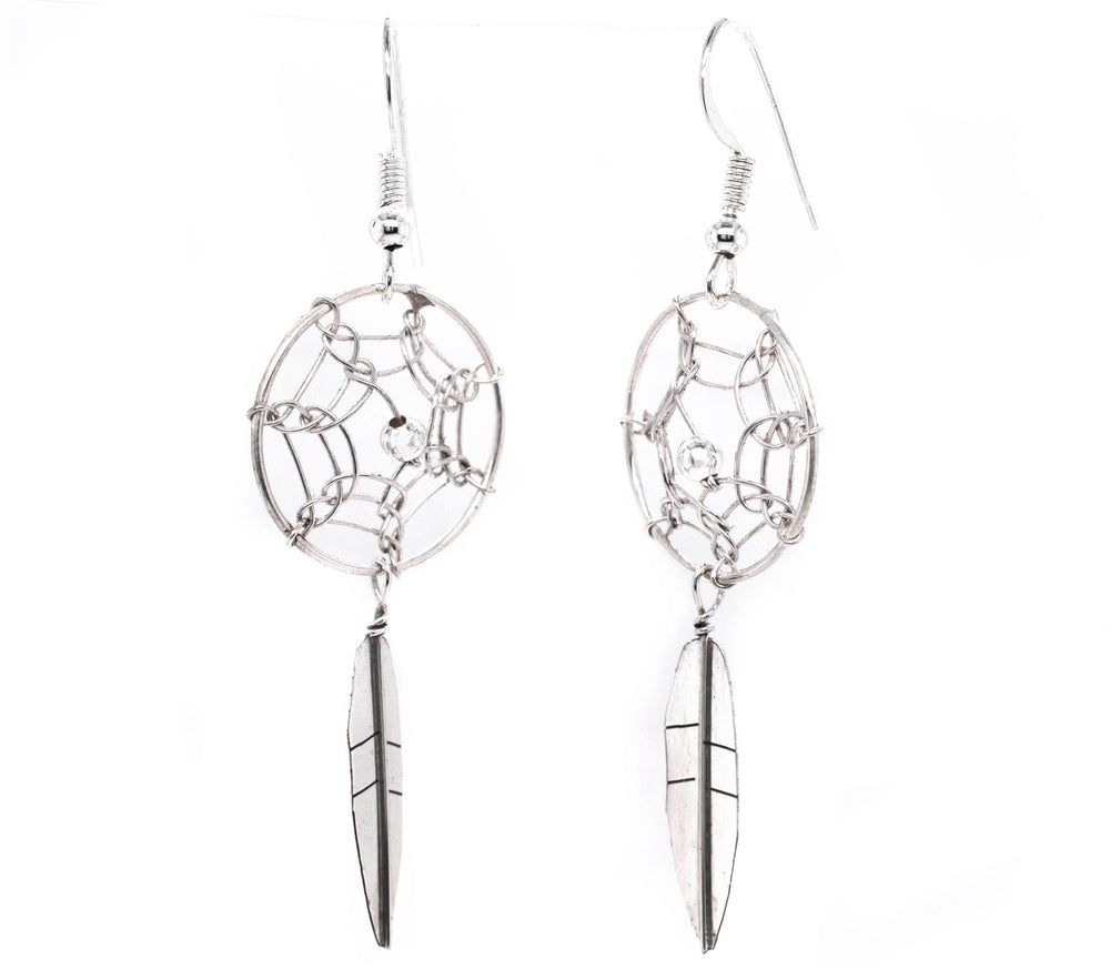 
                  
                    A pair of authentic Super Silver Zuni dreamcatcher earrings on a white background.
                  
                