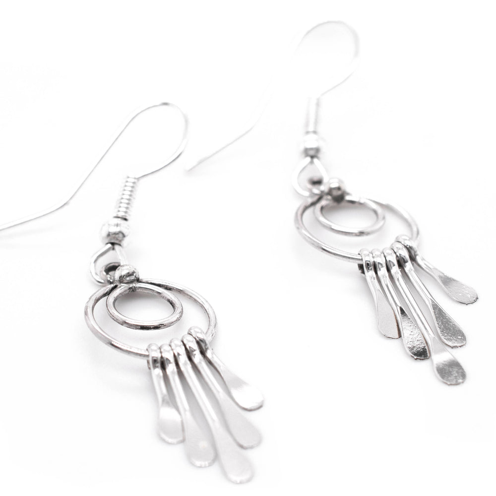 Super Silver's Zuni Silver Waterfall Earrings, handmade Native American earrings with southwest charm, dangling gracefully on a white background.