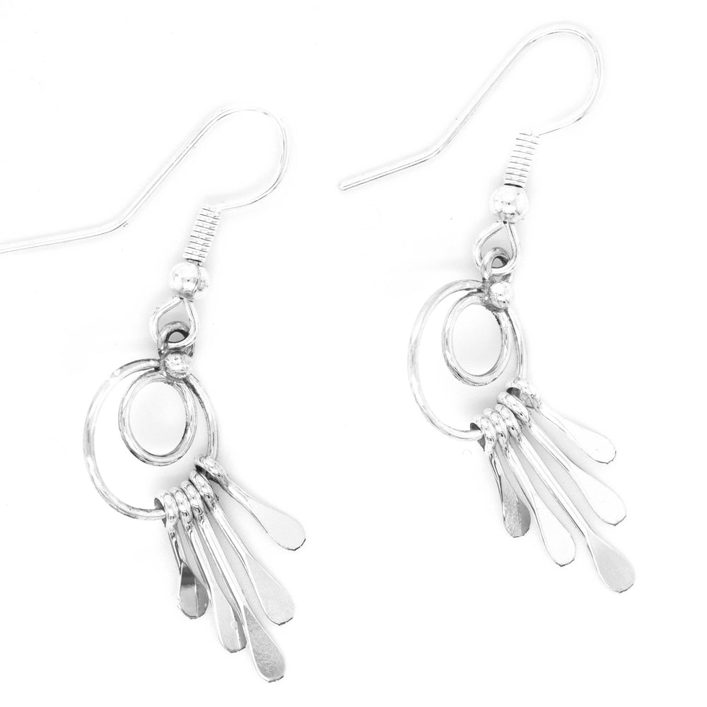 Handmade Zuni Silver Waterfall Earrings by Super Silver dangle gracefully on a white background.