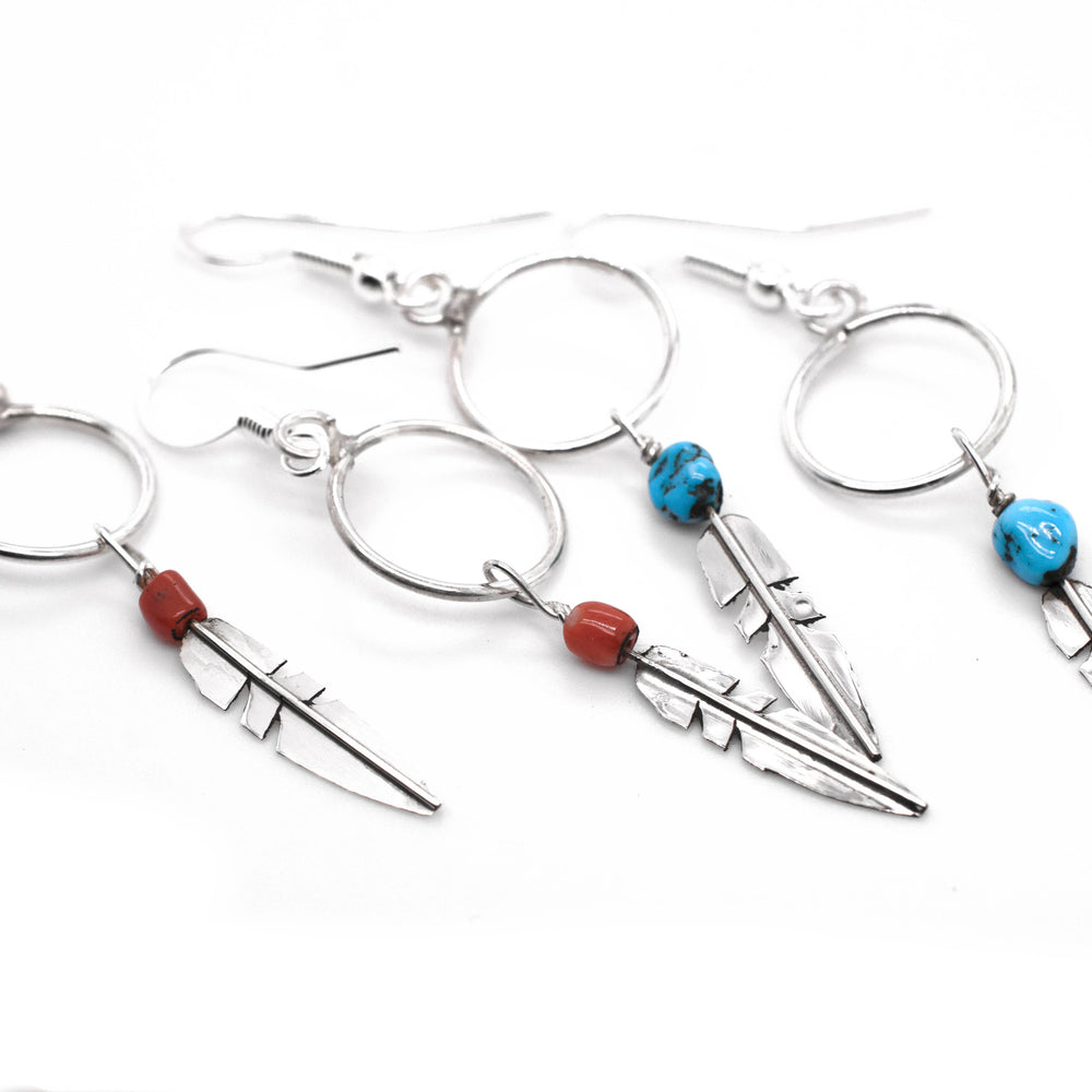 Super Silver's Delicate Zuni Feather Earrings with Coral and Turquoise Beads featuring turquoise accents.