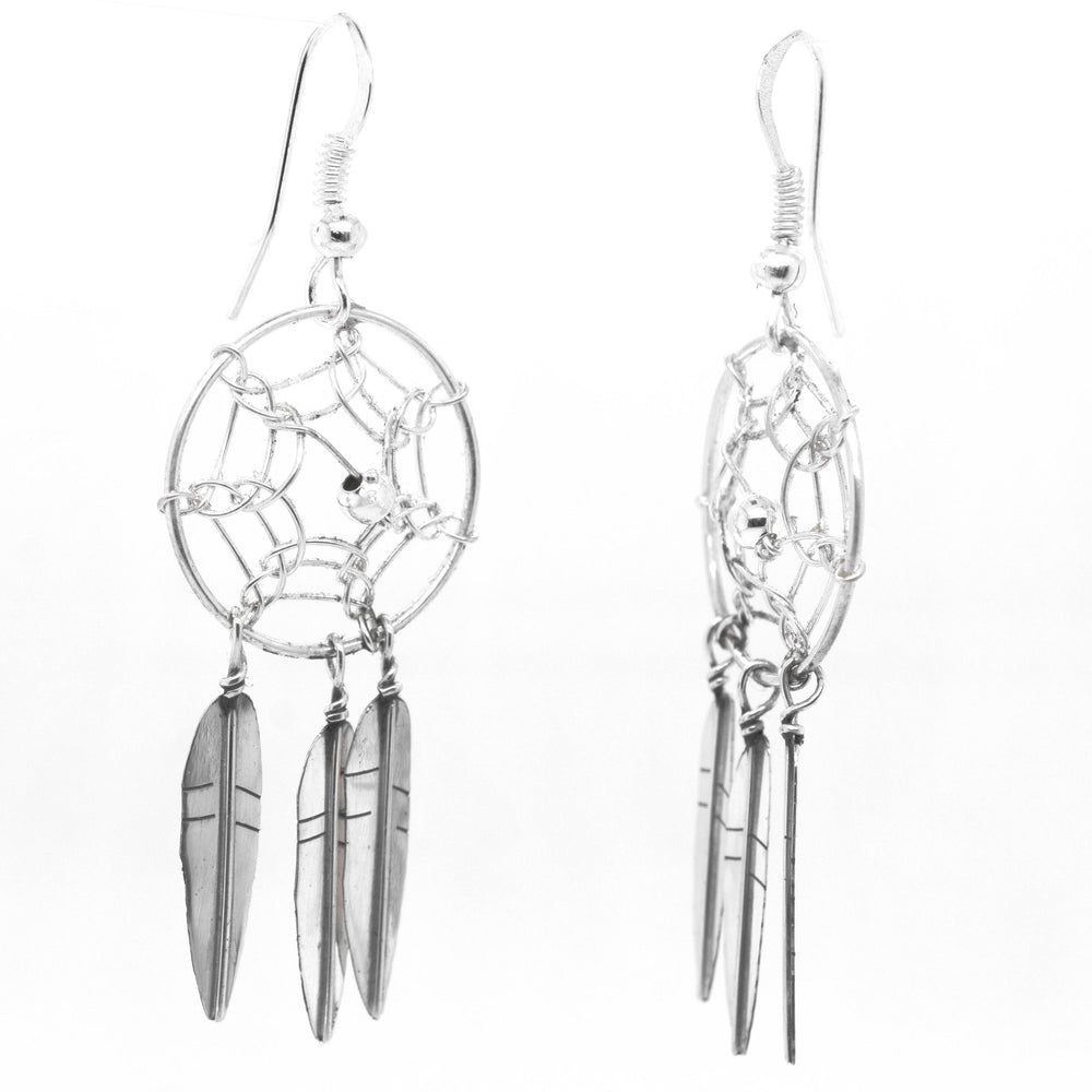 
                  
                    A pair of stunning Zuni Dreamcatcher earrings by Super Silver with feathers. These Zuni dreamcatcher earrings are beautifully adorned with silver feathers, creating a boho charm effect.
                  
                