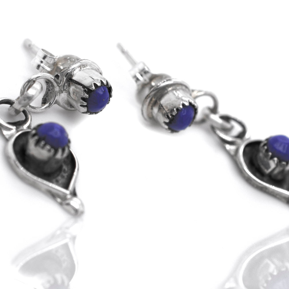 
                  
                    Delicate Zuni Lapis And Coral Earrings, crafted with .925 sterling silver and adorned with lapis stones by Super Silver.
                  
                