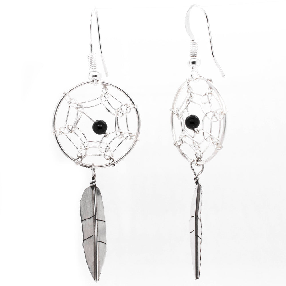 
                  
                    A pair of Super Silver Zuni Dreamcatcher Earrings with Natural Stone Bead and silver and black feathers.
                  
                