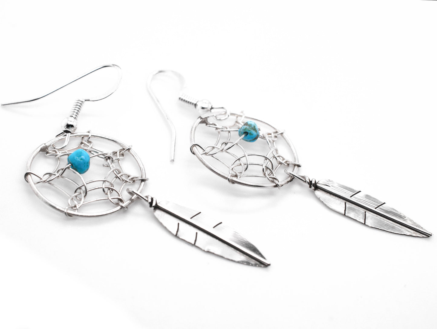 A pair of Zuni Dreamcatcher earrings with natural stone bead adorned with vibrant turquoise stones from Super Silver.