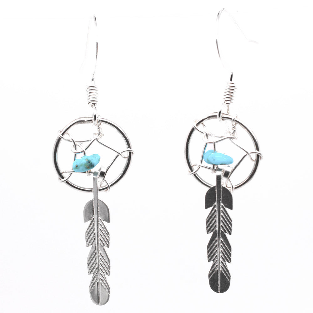 
                  
                    A pair of Super Silver Zuni Turquoise Dreamcatcher Earrings, inspired by Native American Zuni dreamcatchers and adorned with turquoise chip beads.
                  
                