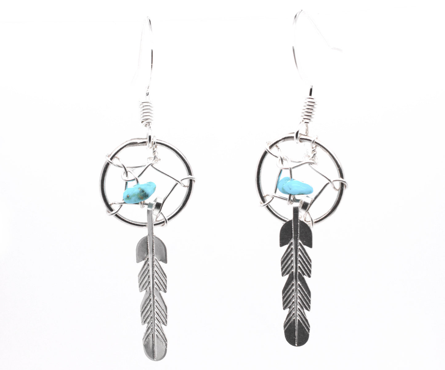 
                  
                    A pair of Super Silver Zuni Turquoise Dreamcatcher Earrings, inspired by Native American Zuni dreamcatchers and adorned with turquoise chip beads.
                  
                