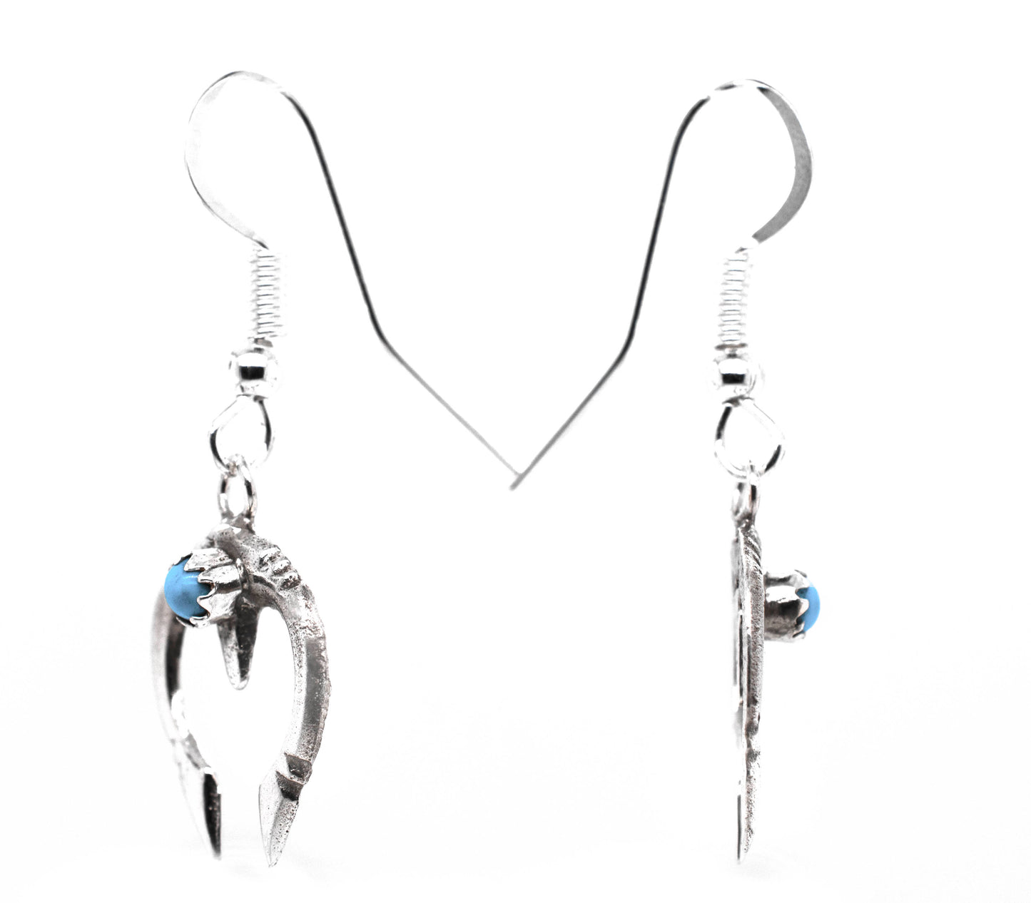 
                  
                    A pair of Super Silver Dainty Naja Turquoise Earrings with turquoise stones.
                  
                